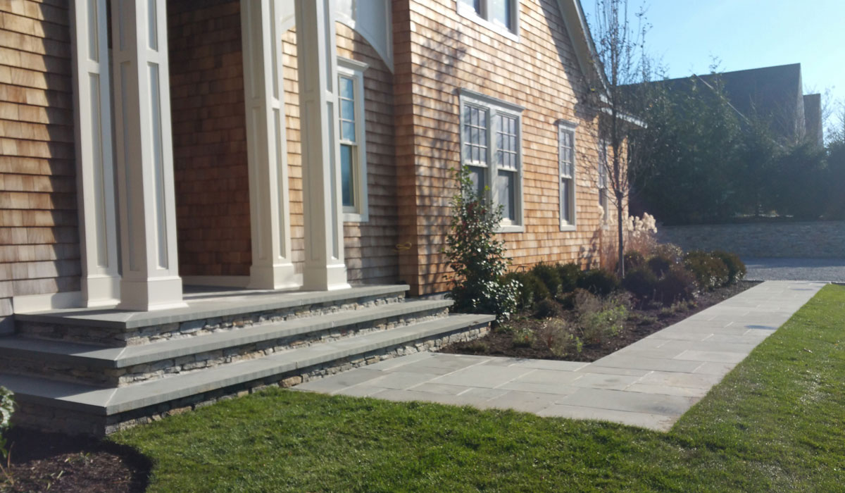 Southampton Masonry Design, Bluestone Home Entrance, Walkway, Stone Facing, Gravel Driveway and Stone Faced Retaining Wall
